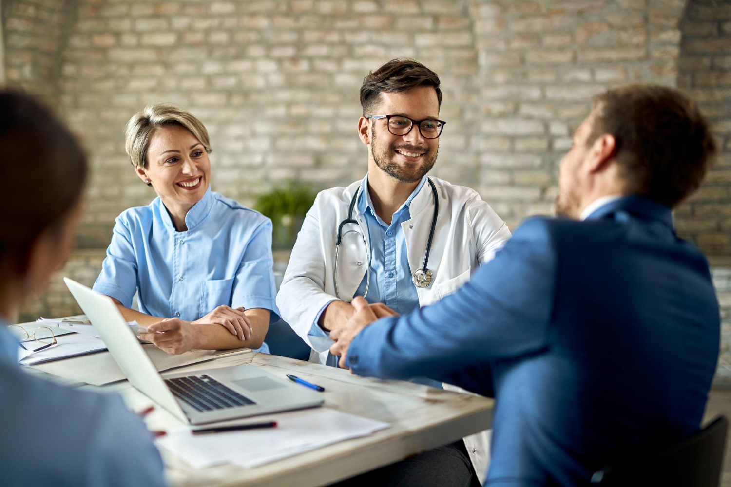 Healthcare professionals at Avento Health discussing PRN staffing solutions and long-term recruiting services in Los Angeles.
